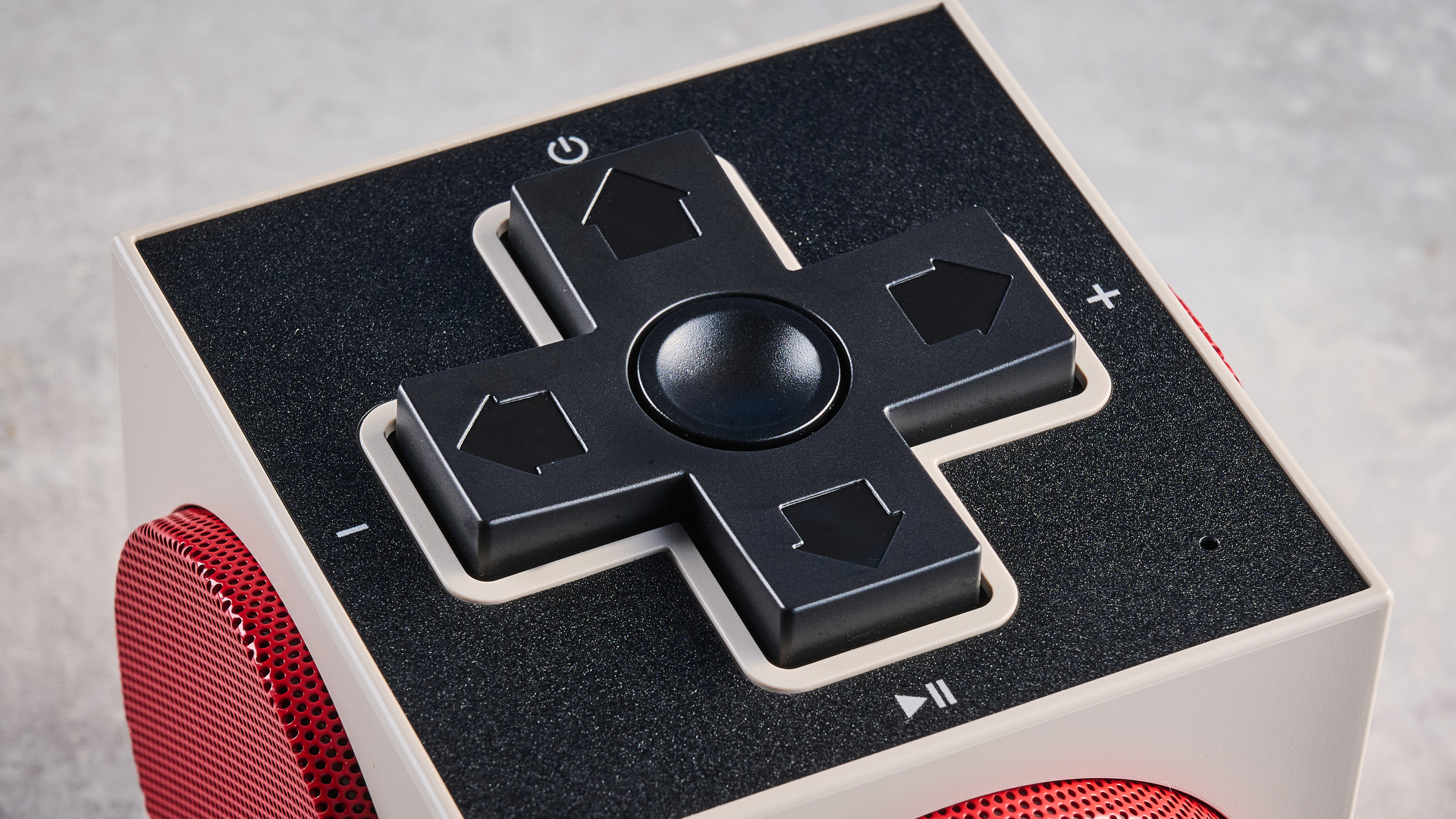 A beige, red and black 8BitDo Retro Cube 2 Bluetooth speaker