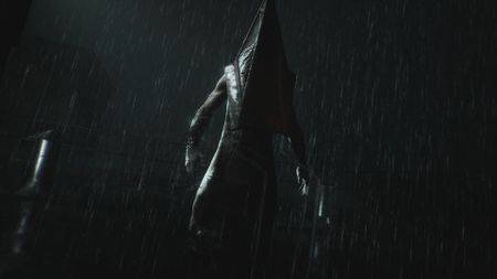 Pyramid Head stands ominously in the rain in Silent Hill 2 remake