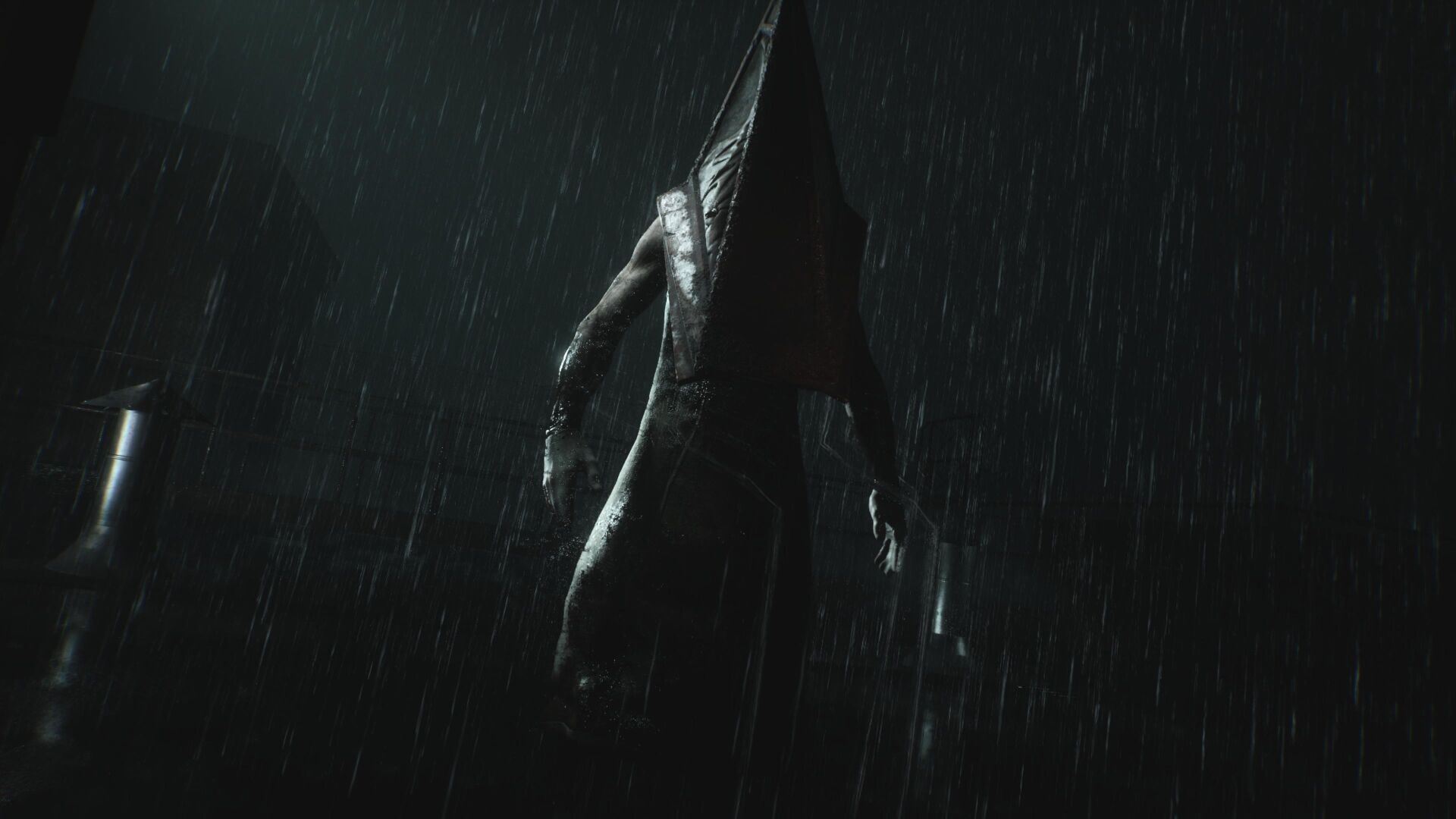 Pyramid Head stands ominously in the rain in Silent Hill 2 remake