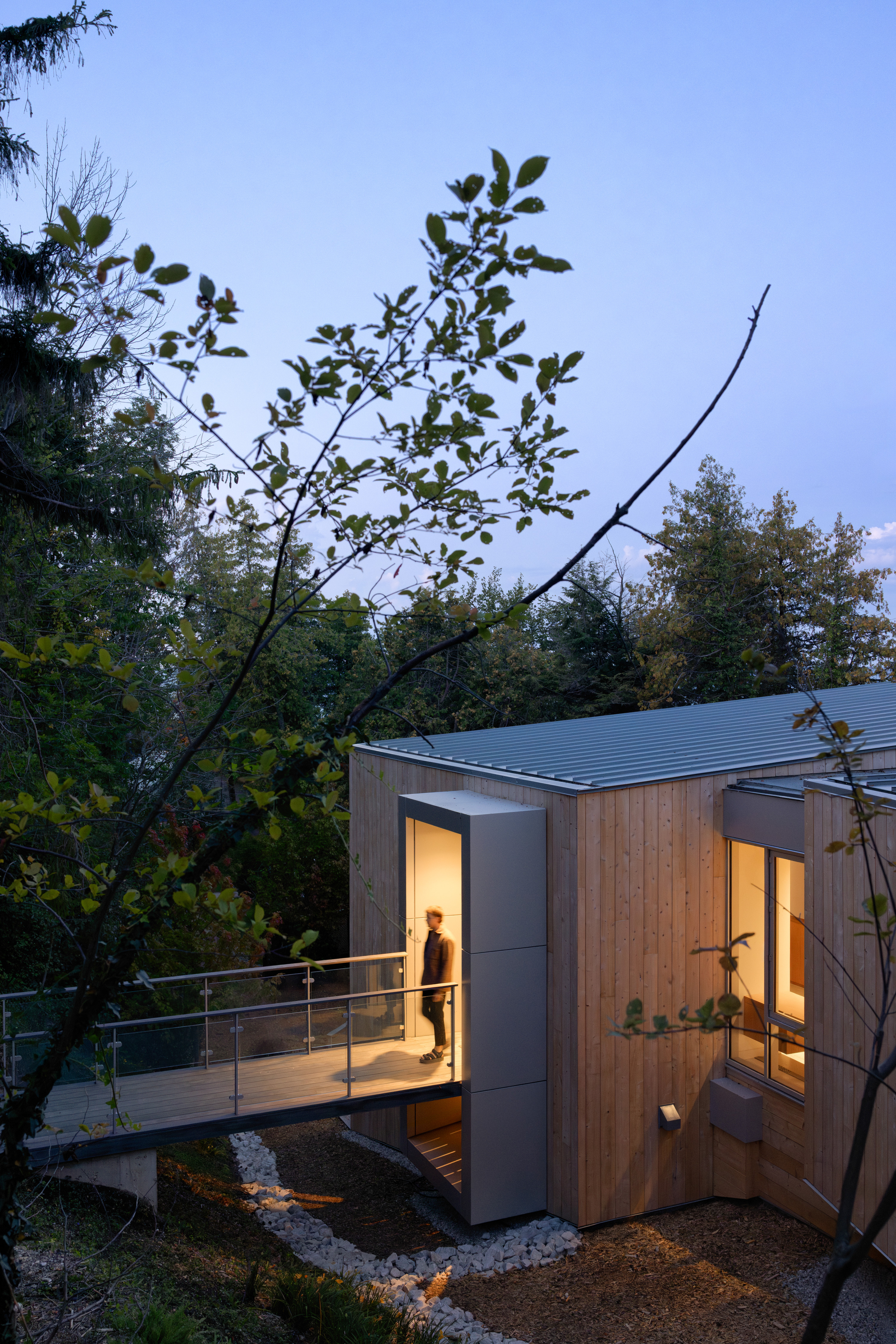 The house is entered across a bridge at the uppermost level