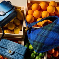 Three of the best new season designer handbags have been photographed from above on top of piles of fruit