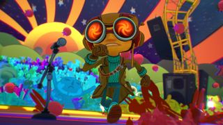 Ray runs across a psychedelic-themed stage, wearing his orange goggles