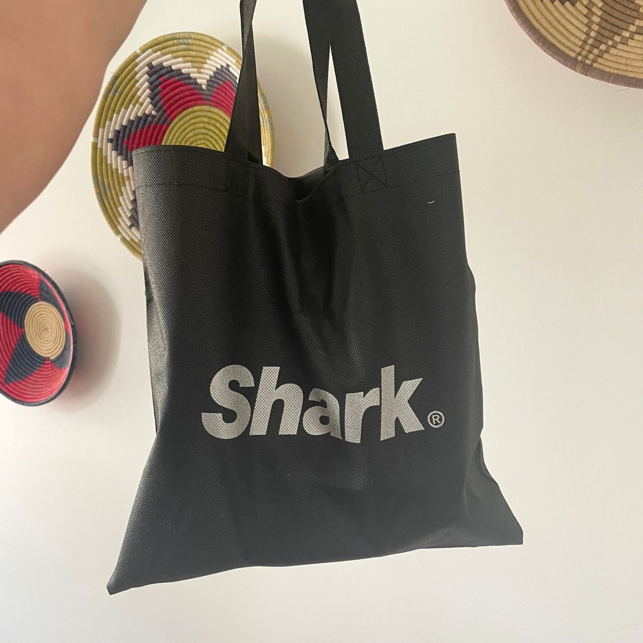 Hand holding up a Shark vacuum accessory bag