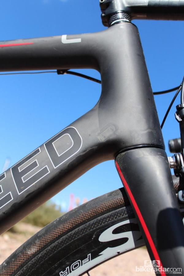 The tall down tube and broad head tube were designed not for aero looks but to brace against the forces of aggressive cornering and descending