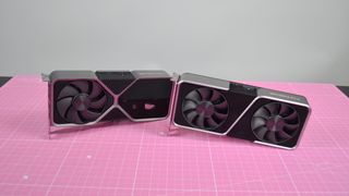 The Nvidia RTX 4070 and RTX 3070 pictured side-by-side on a pink worksurface.