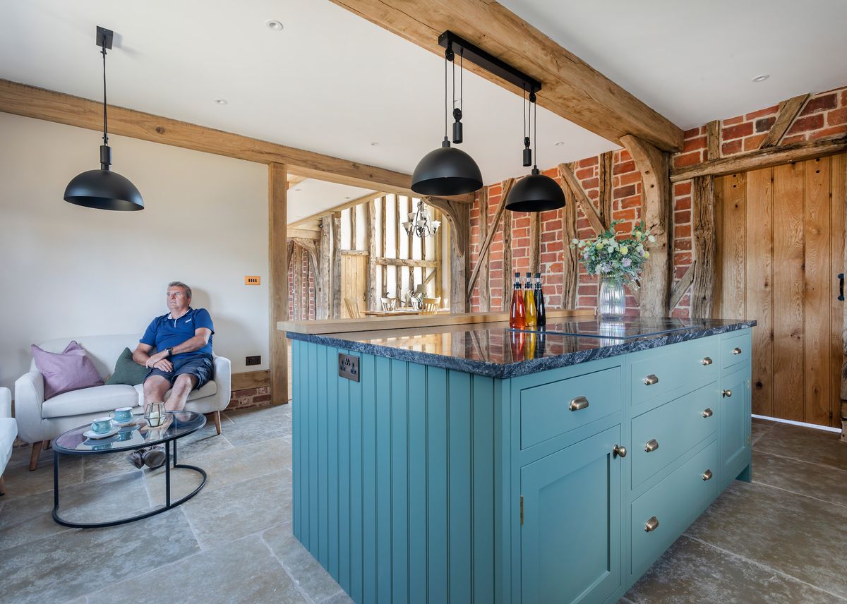 A traditional shaker style kitchen with an island in a barn conversion