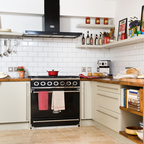 kitchen with white tiles on wall and chimney