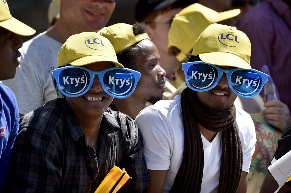 Supporters wearing giant glasses wait along the road during the 13.8 km individual time-trial, the first stage of the 102nd edition of the Tour de France