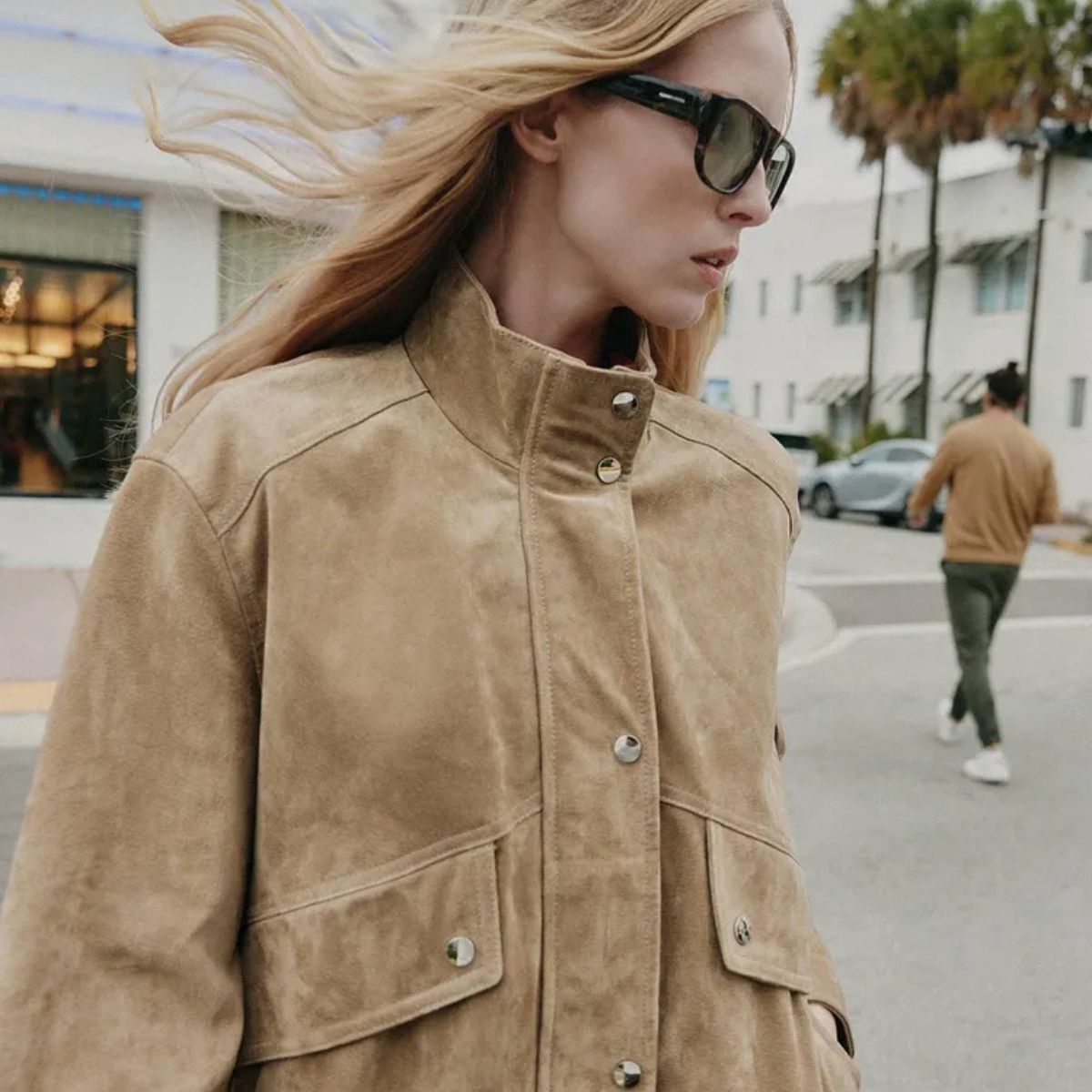 Woman wears light taupe suede bomber jacket