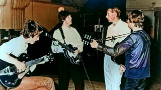 Rock and roll band "The Beatles" pose for a portrait in the studio with their producer George Martin in cicra 1964. (L-R) George Harrison, Paul McCartney, George Martin, John Lennon.