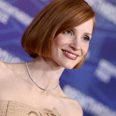 a white woman with short, red hair attends a red carpet event