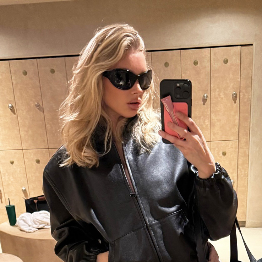 Elsa Hosk wearing a black leather jacket, pink Alo shorts, and pink cap-toe Chanel ballet flats