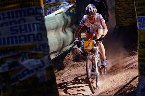 Lisi Osl rides through the dust and trees on her way to a win.