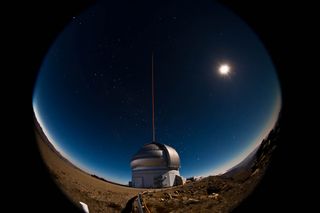 The Gemini South telescope on the night of January 21-22, 2011 during the first propagation of the GeMS laser guide star system on the sky. A bright gibbous moon illuminates the landscape for this 20-second fisheye lens view.