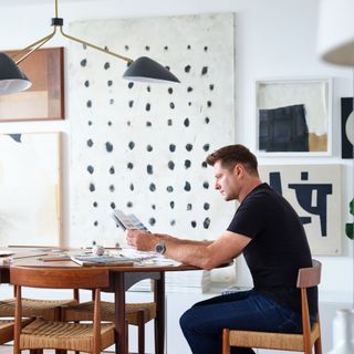 George Clarke sitting at dining table