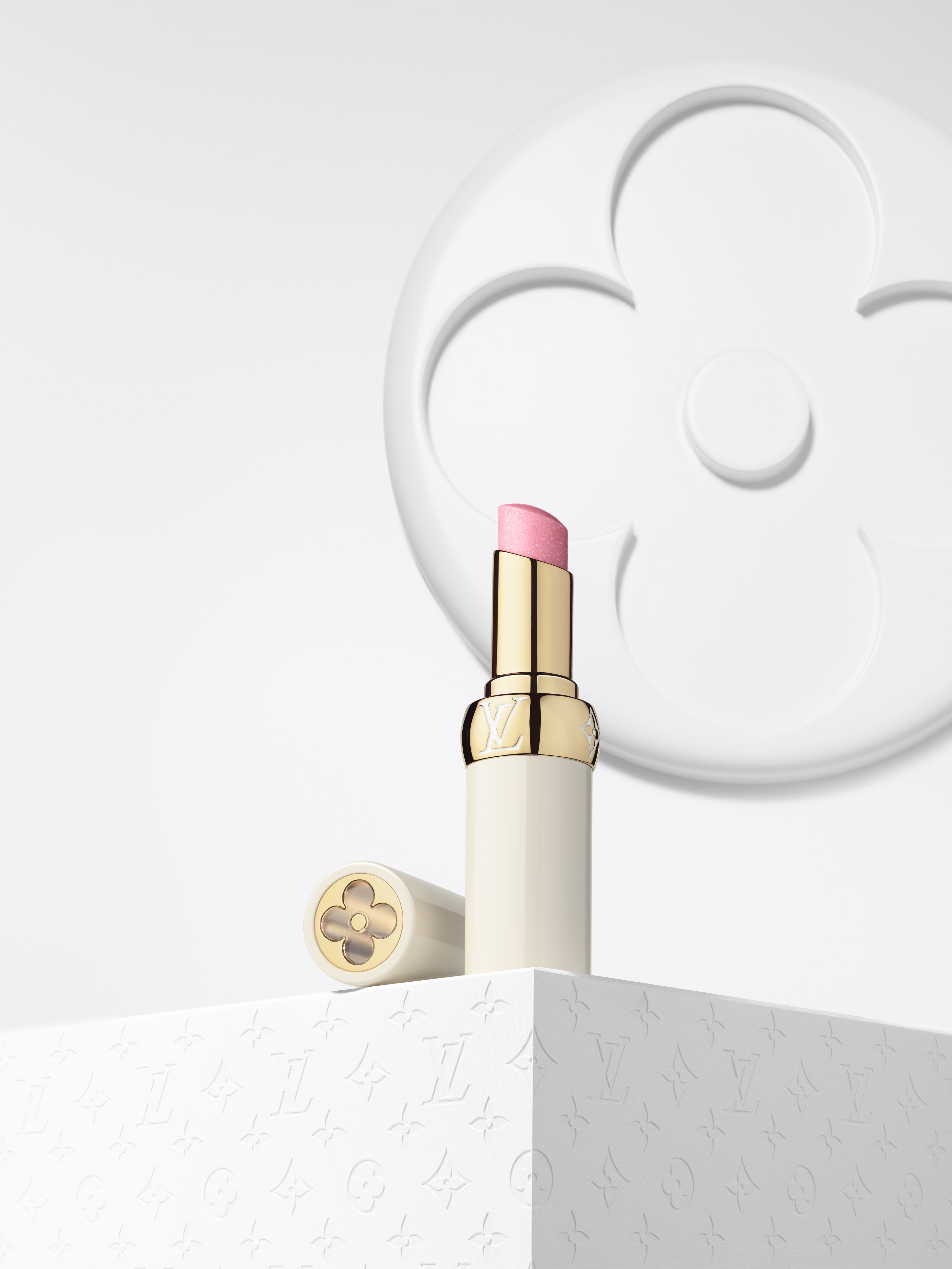 a pink lip balm in a white tube