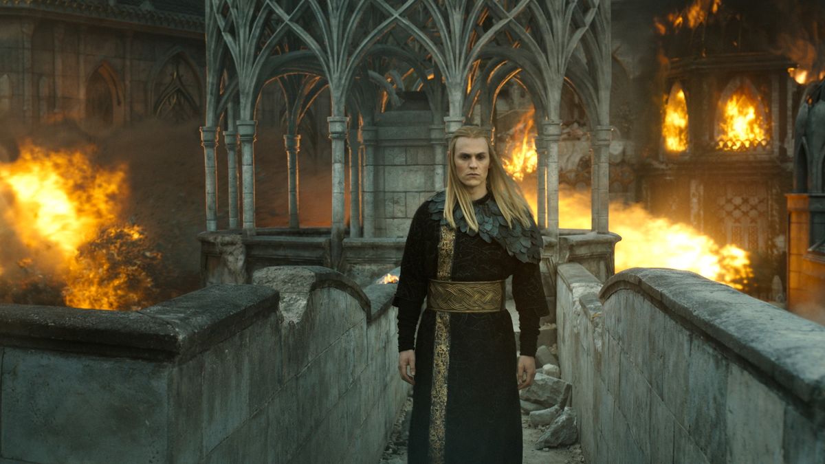 Annatar/Sauron (Charlie Vickers) stands on a bridge as flames erupt through town behind him in &quot;The Lord of the Rings: The Rings of Power&quot; season 2