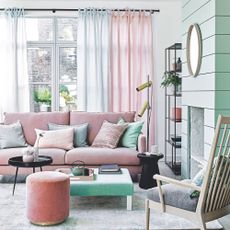 A blue and pink living room with natural accents