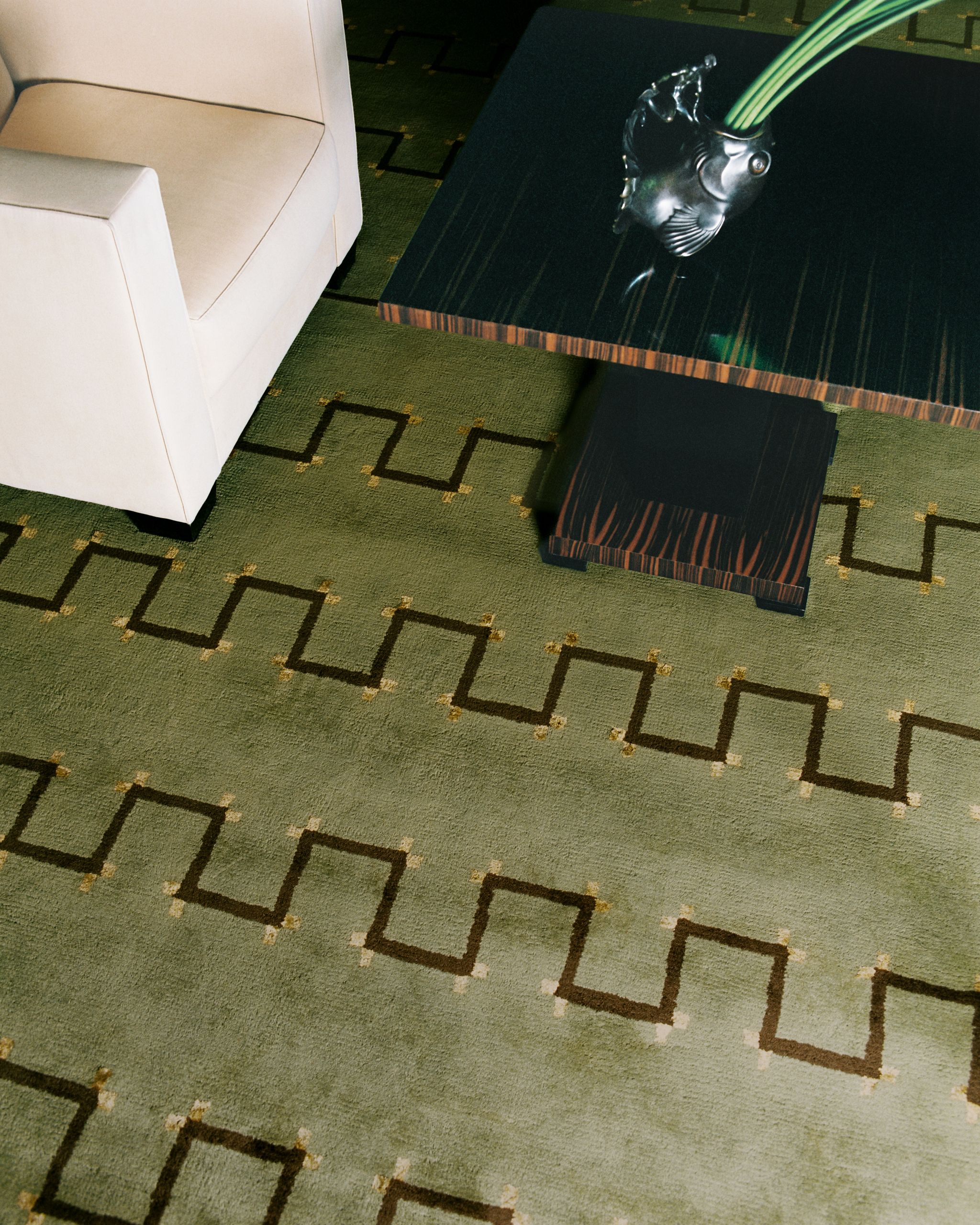 Overhead view of a green rug with squiggly lines running through it.