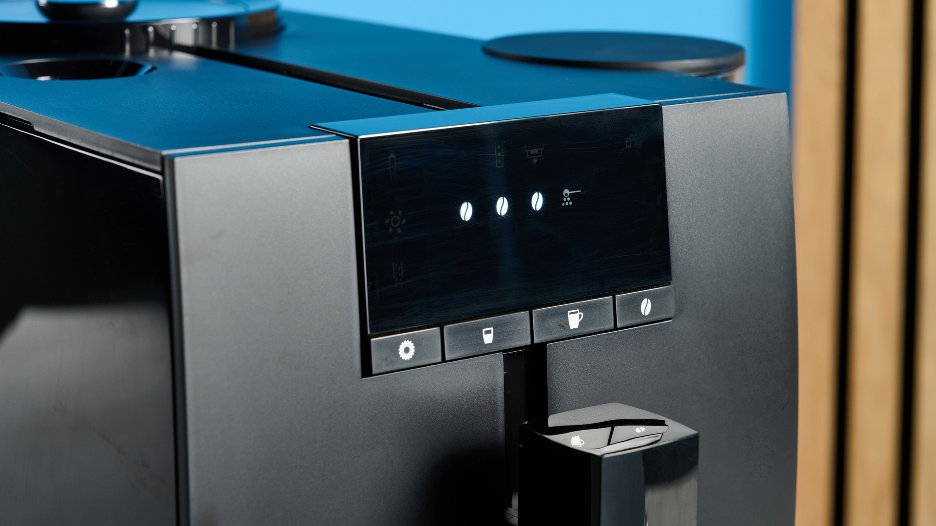 the jura ena 4 automatic coffee machine in piano black with a faceted water tank and bright screen