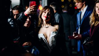 Jenna Ortega taking a selfie with a fan at the Scream VI premiere
