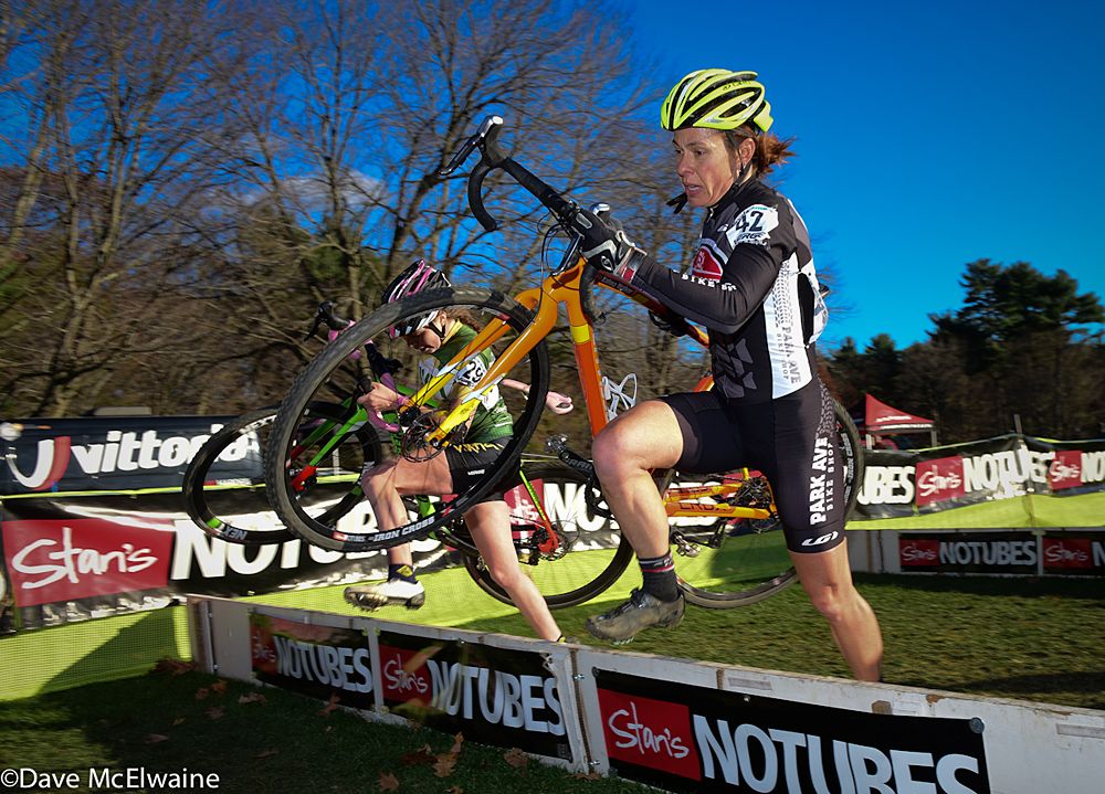 Katina Walker (Park Ave. Bike Shop) running the barriers with one lap remaining