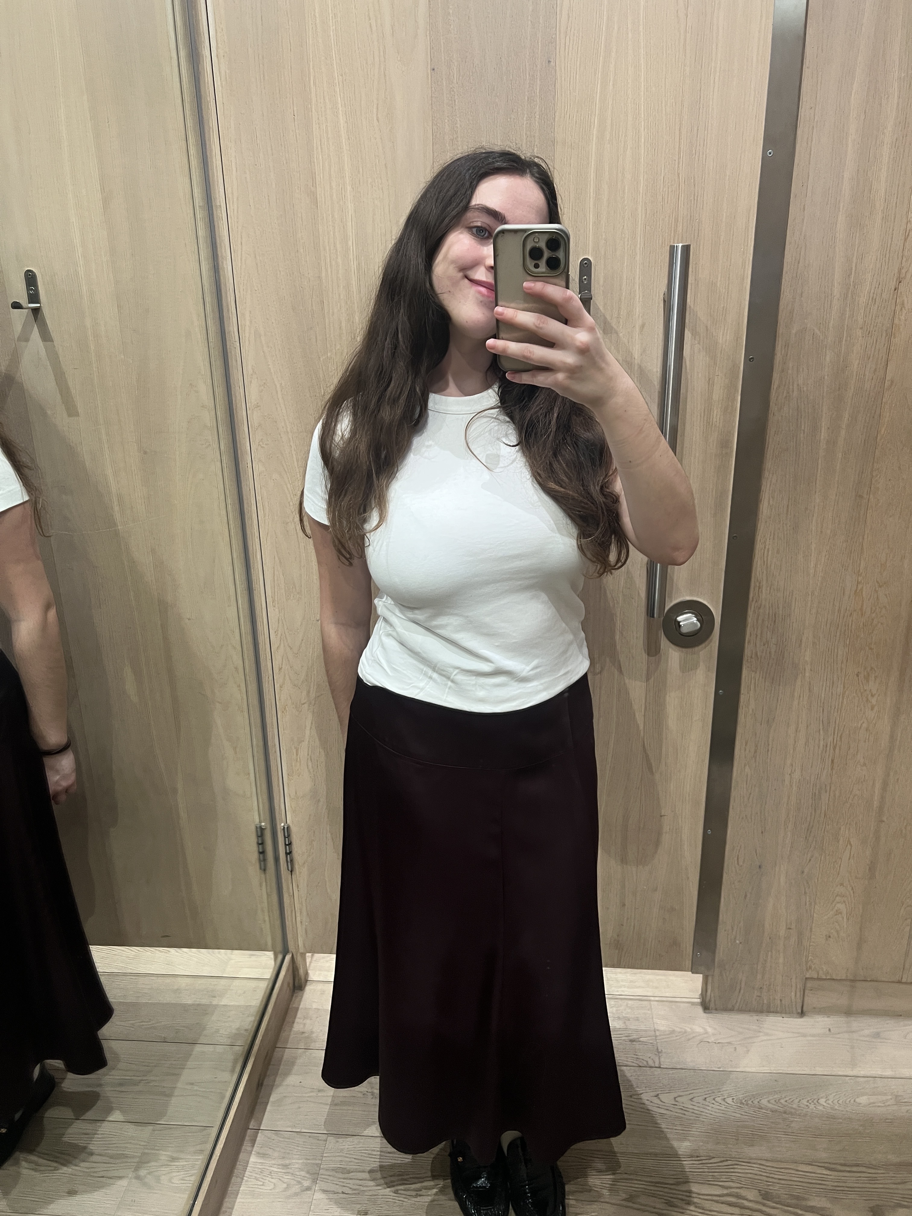 An image of Who What Wear UK's SEO Writer Ava Gilchrist wearing a satin skirt from Whistles.