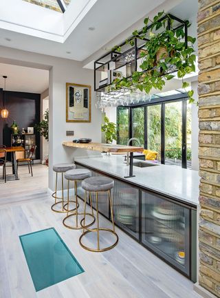 Kitchen with white walls, high storage and bar area