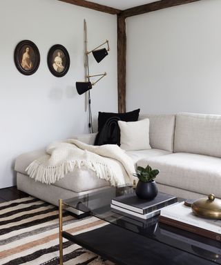 snug room with whitewashed wall and l-shaped sofa