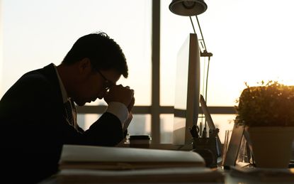 Exhausted businessman having moment of rest in office