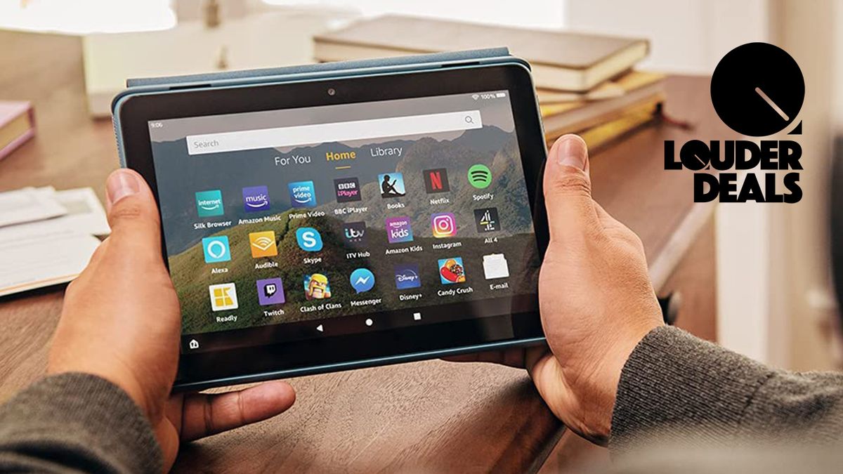 Best Prime Day tech deals: man holding a Fire tablet