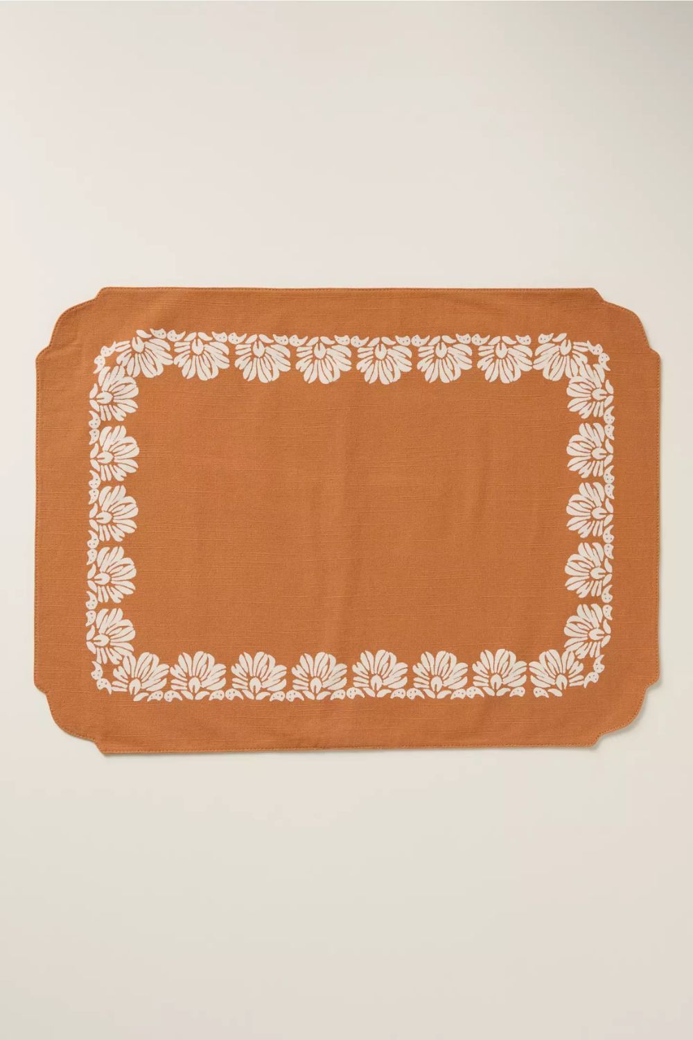 Orange cotton placemat with white floral border