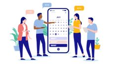 An illustration of four people stood around a giant phone displaying a calendar, holding clipboards and with speech bubbles above their heads to represent schedule planning within the workplace. The two women in the group are wearing salmon pink and mustard yellow shirts, respectively, while the two men are wearing blue shirts. Behind the phone, potted plants can be seen against a white background.