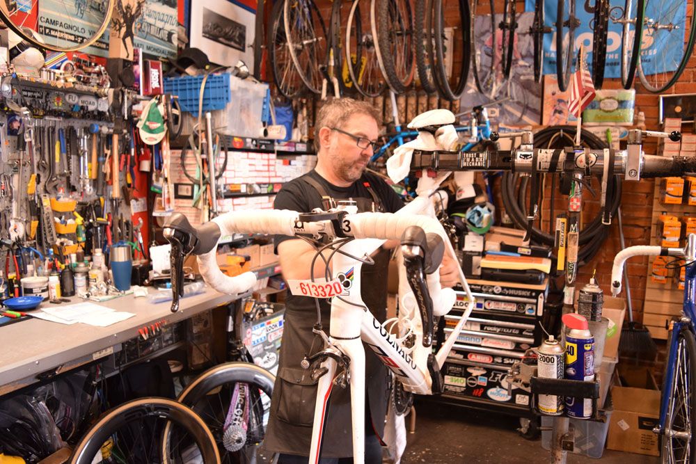 Owner Jim Potter works on one of the bikes brought in by a Vecchio's regular