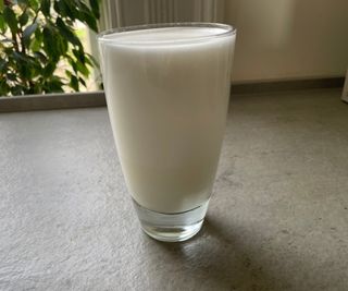 A glass of milk textured in the Instant milk frother