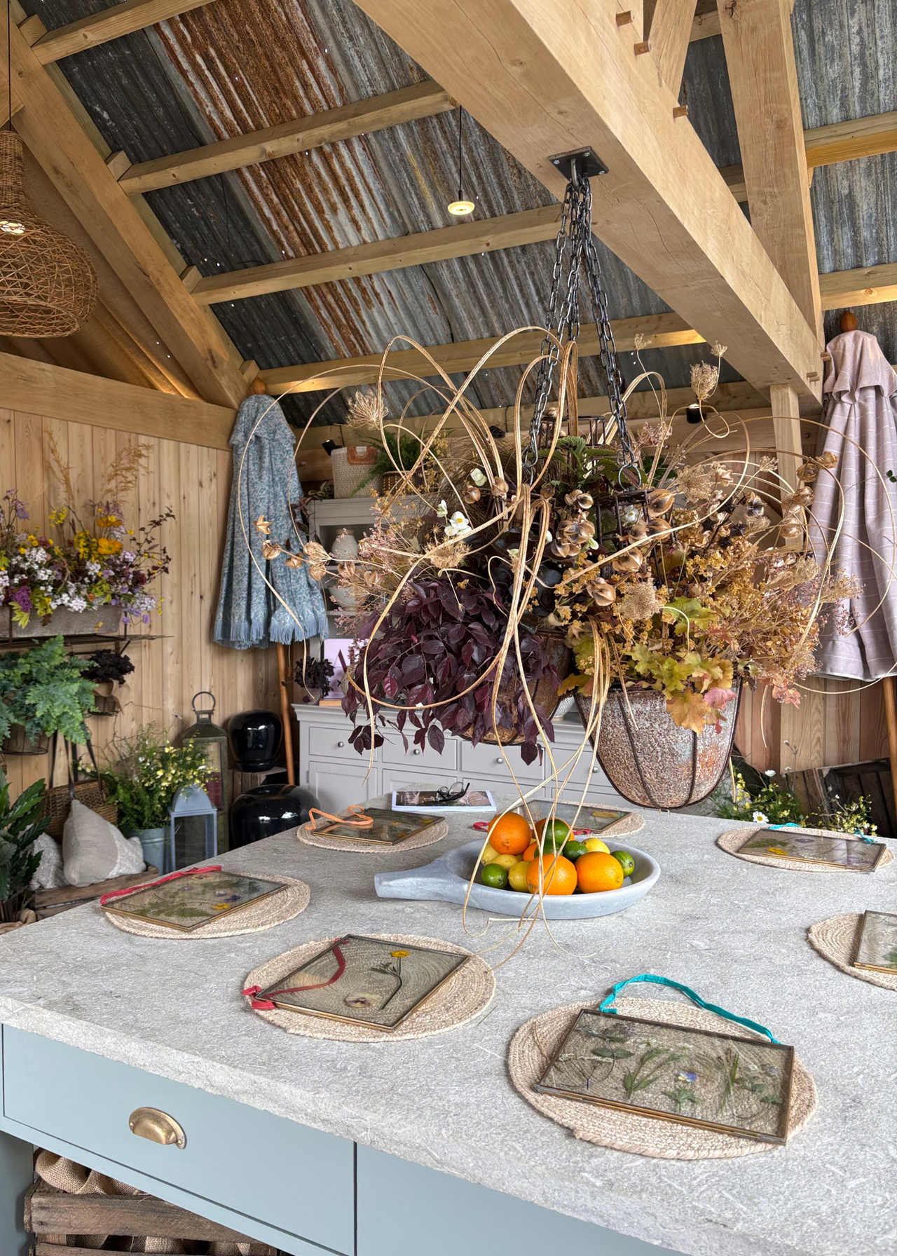 An outdoor kitchen island set for dinign at the Chelsea Flower Show 2026