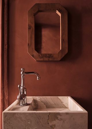 A bathroom with burgundy walls