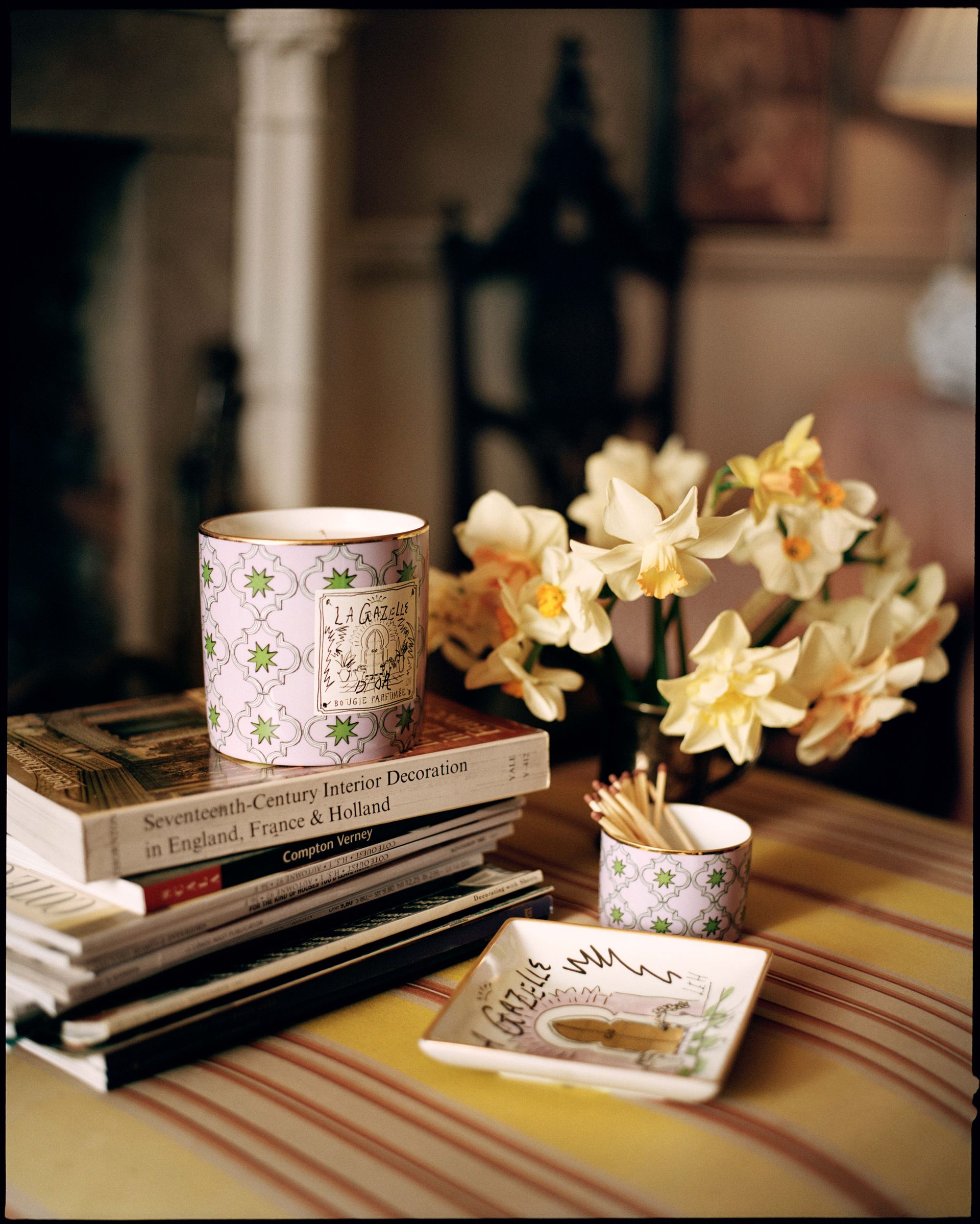 Ginori 1735 home fragrance candle on top of a pile of books