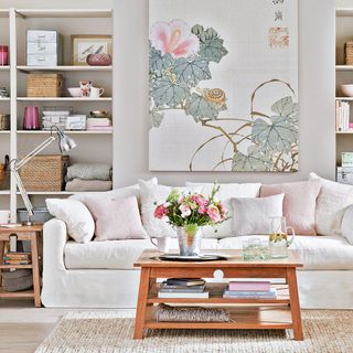 White living room with white sofa and floral print