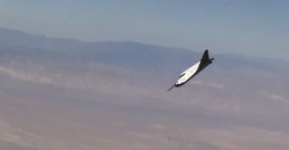 Sierra Nevada Corp.'s Dream Chaser space plane prototype soars down to Earth with mountains as a backdrop in this still from an Oct. 26, 2013 drop test at Edwards Air Force Base in California.