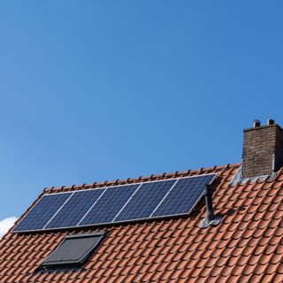 house roof with solar panels and window