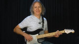 A screenshot of Guitar Tricks&#039; Dave Celentano playing a Strat during his rock guitar instructional video.