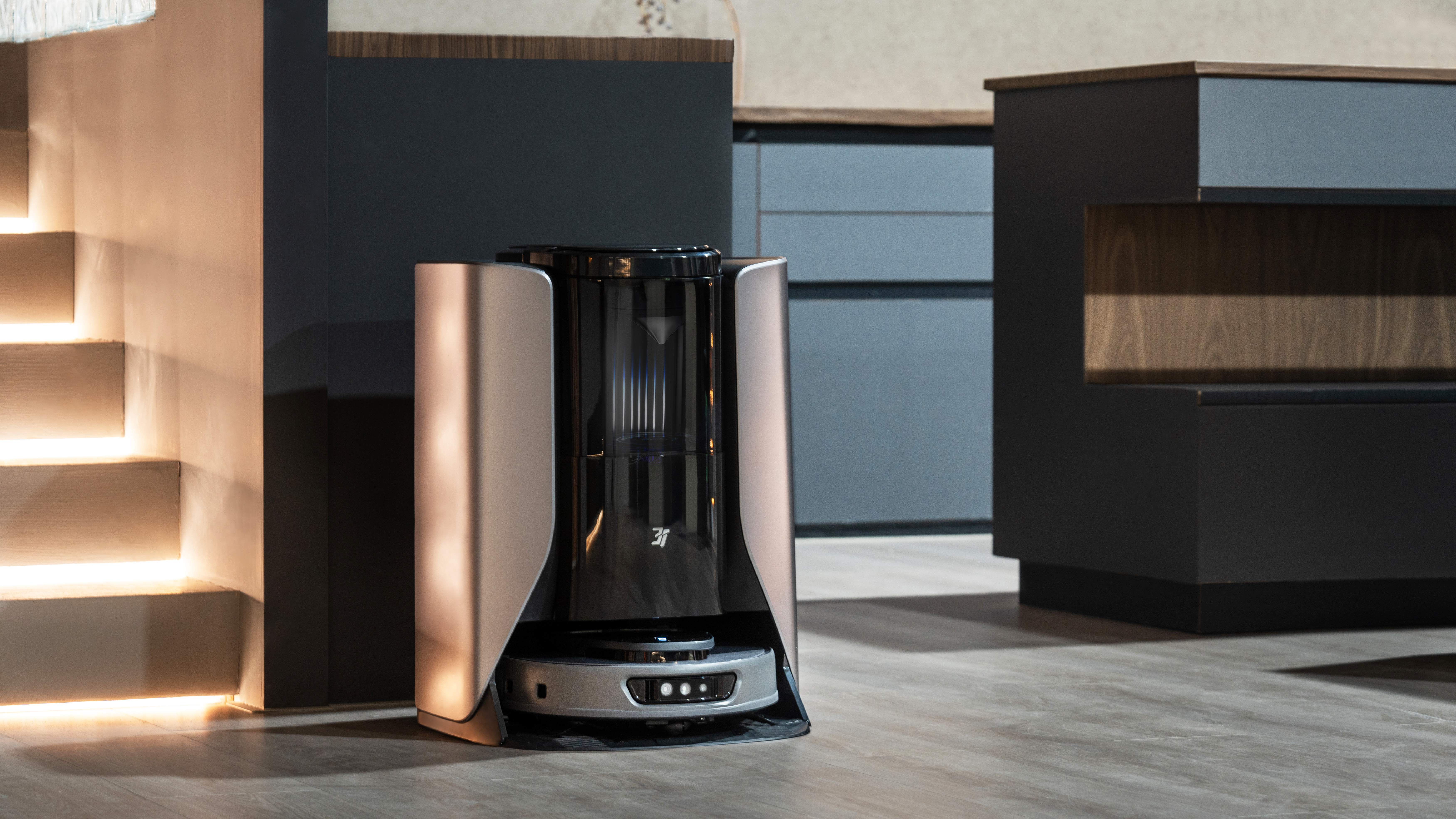 3i robot vacuums shown in a modern living room area.