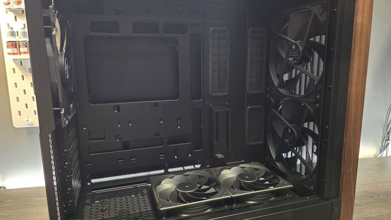 A Lian Li Lancool 217 on a desk with various components installed inside it.
