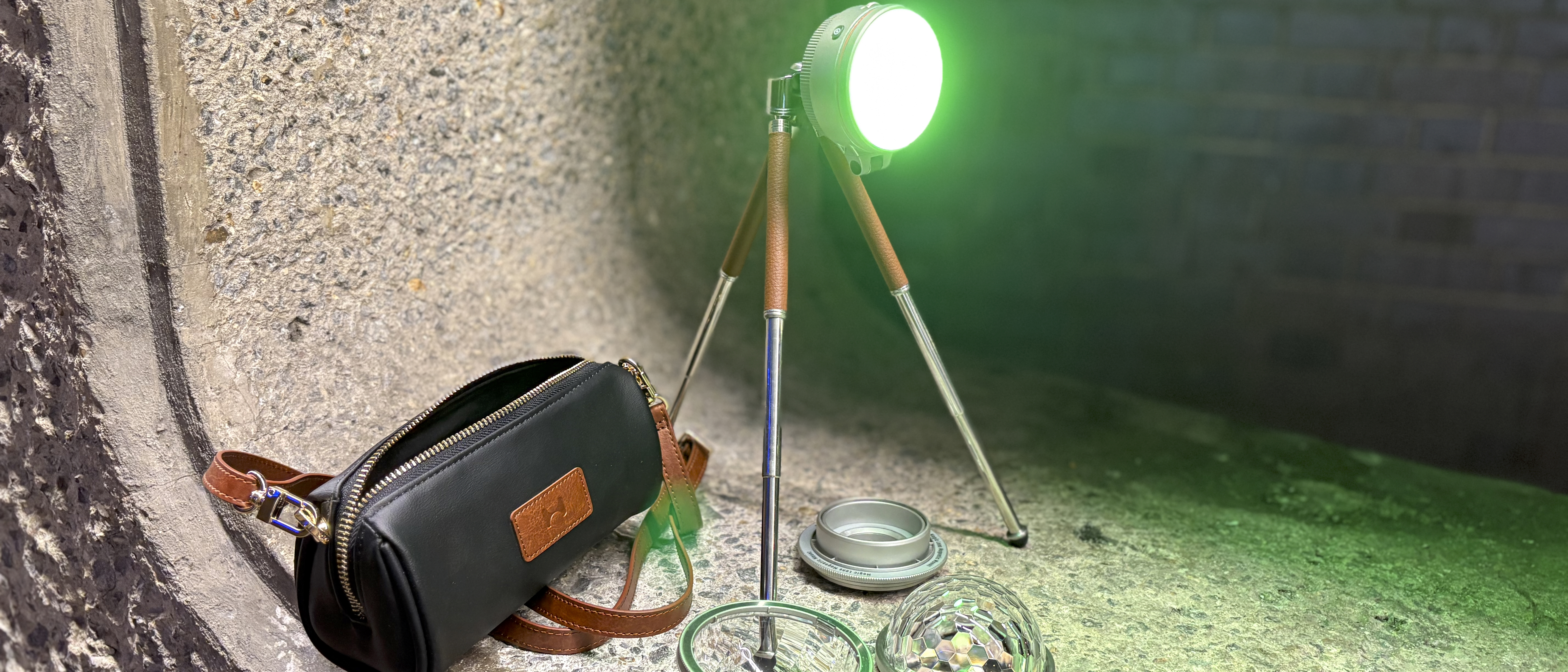 Close shot of the tripod-mounted Sol 5 Spectra plus accessories including the domed Magic Lens and the faux leather carry bag