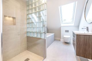 a loft conversion bathroom with large format tiles