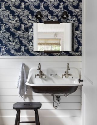 Half bath with panelling and blue wallpaper