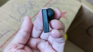 Our reviewing displaying the EarFun Air Pro SV's touch sensor