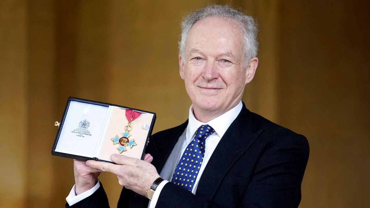 James Daunt poses with his medal after being appointed a Commander of the Order of the British Empire