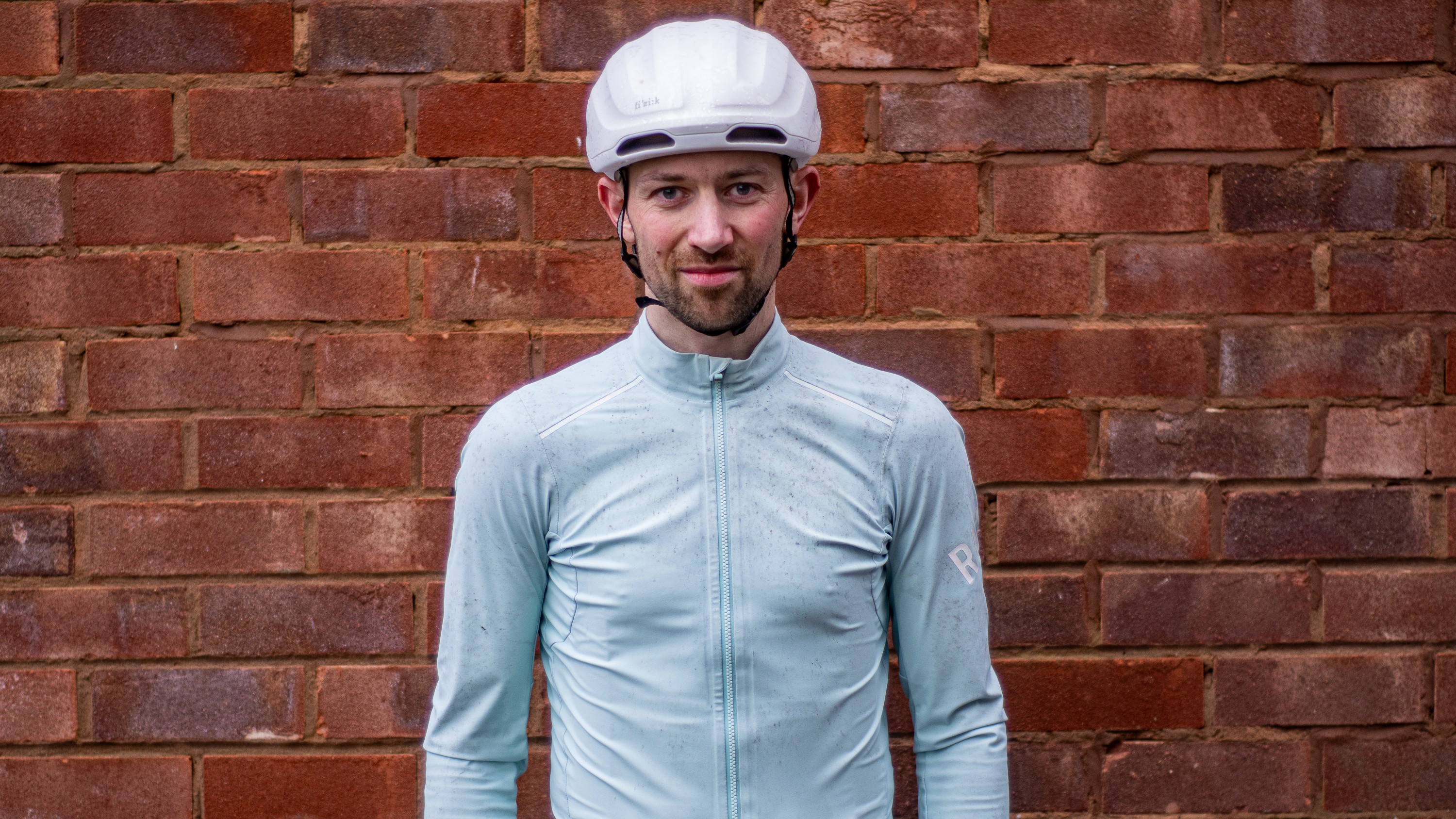 A man wearing a green Rapha Shadow jersey 